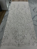 Silver sequin fabric on a white surface