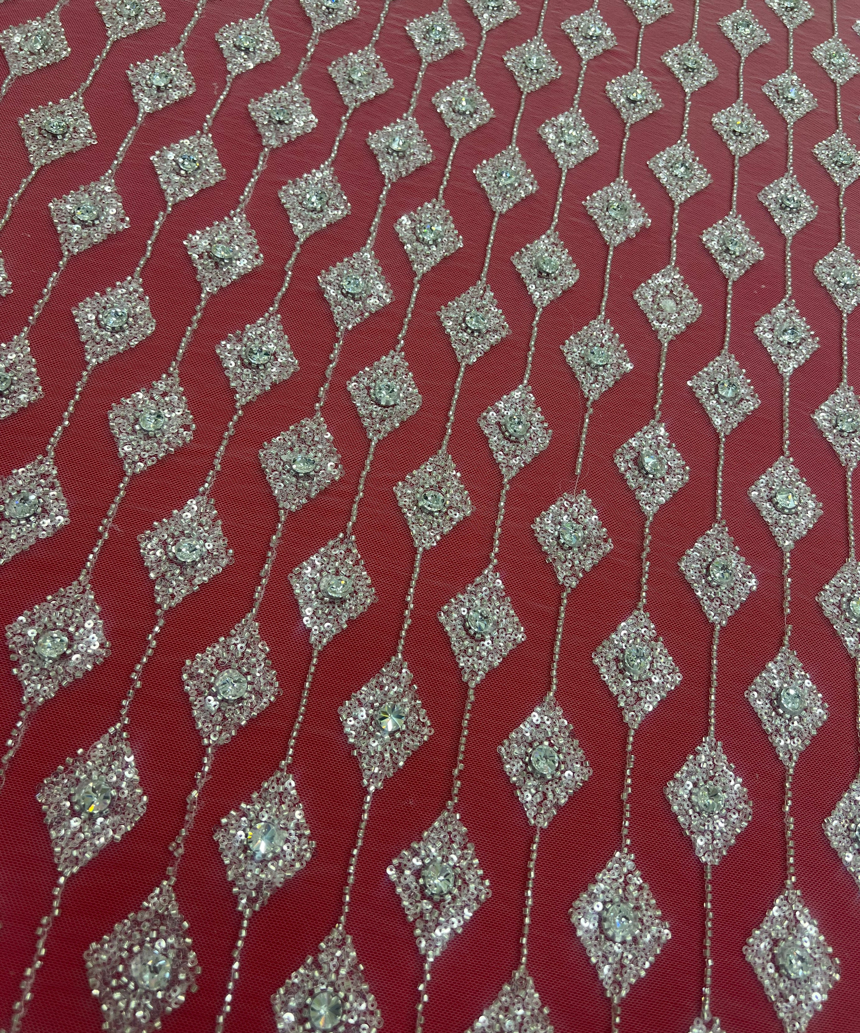 Embroidered lace with shimmering stones in a graduated geometric design