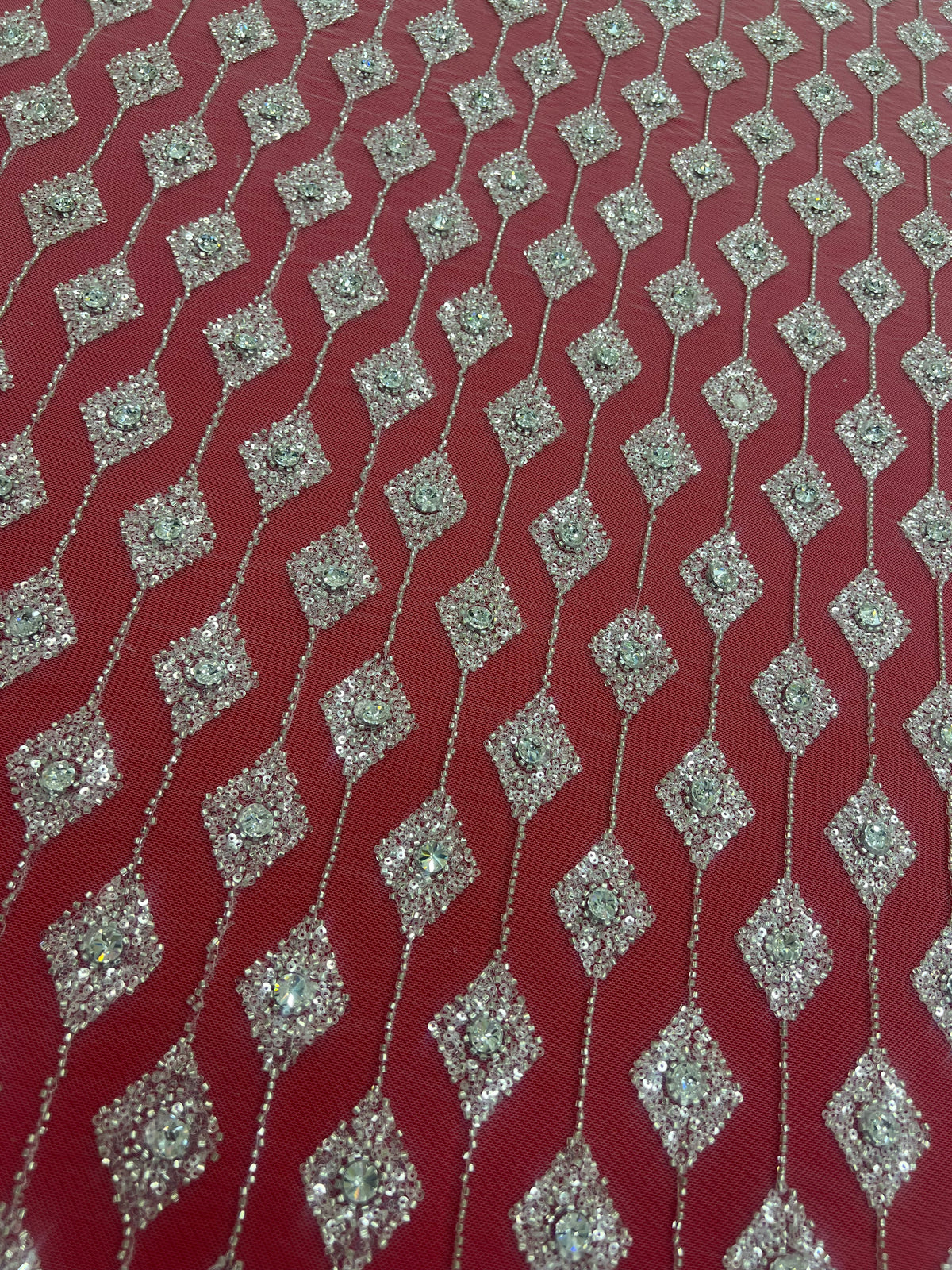 Embroidered lace with shimmering stones in a graduated geometric design