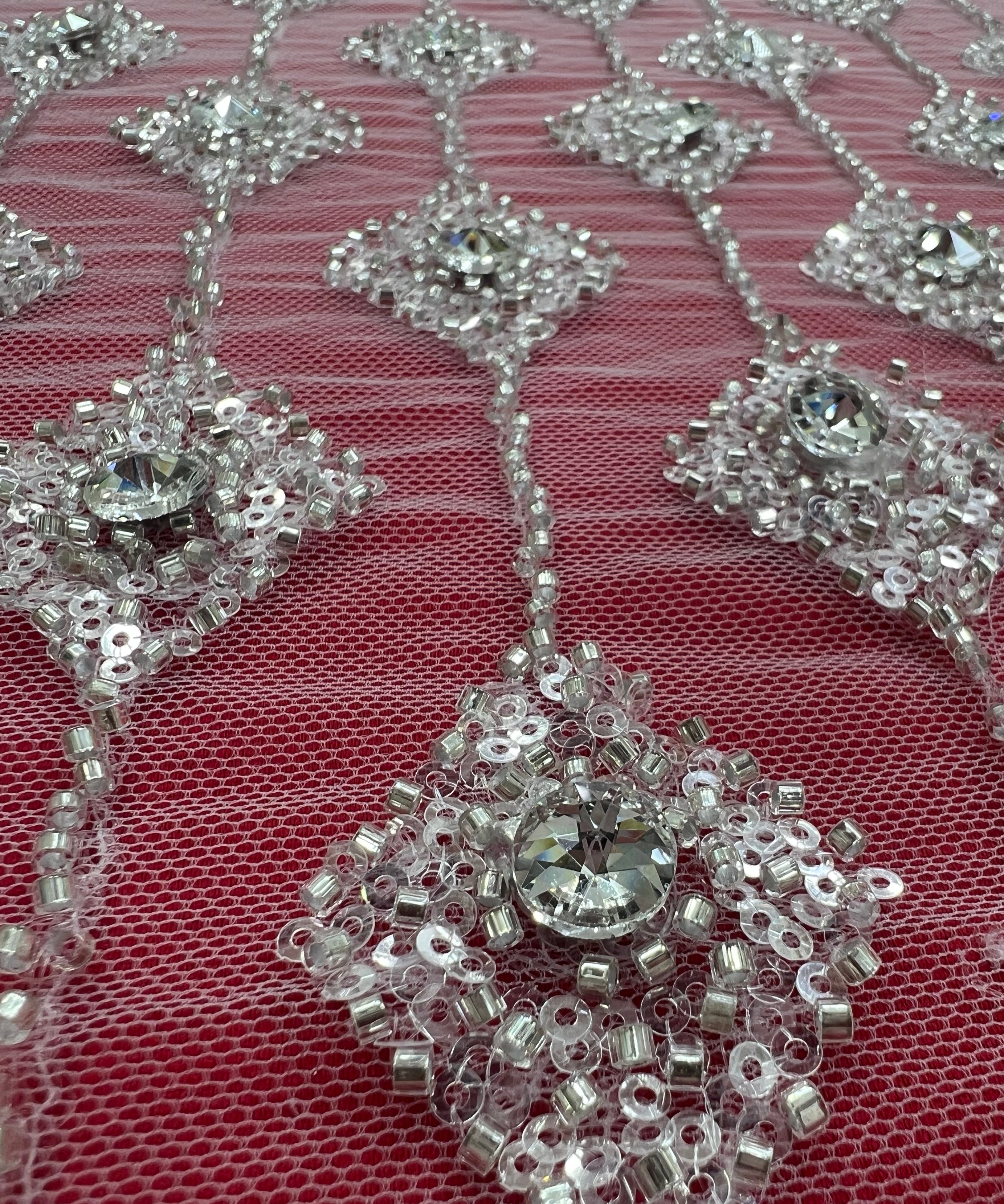 Embroidered lace with shimmering stones in a graduated geometric design