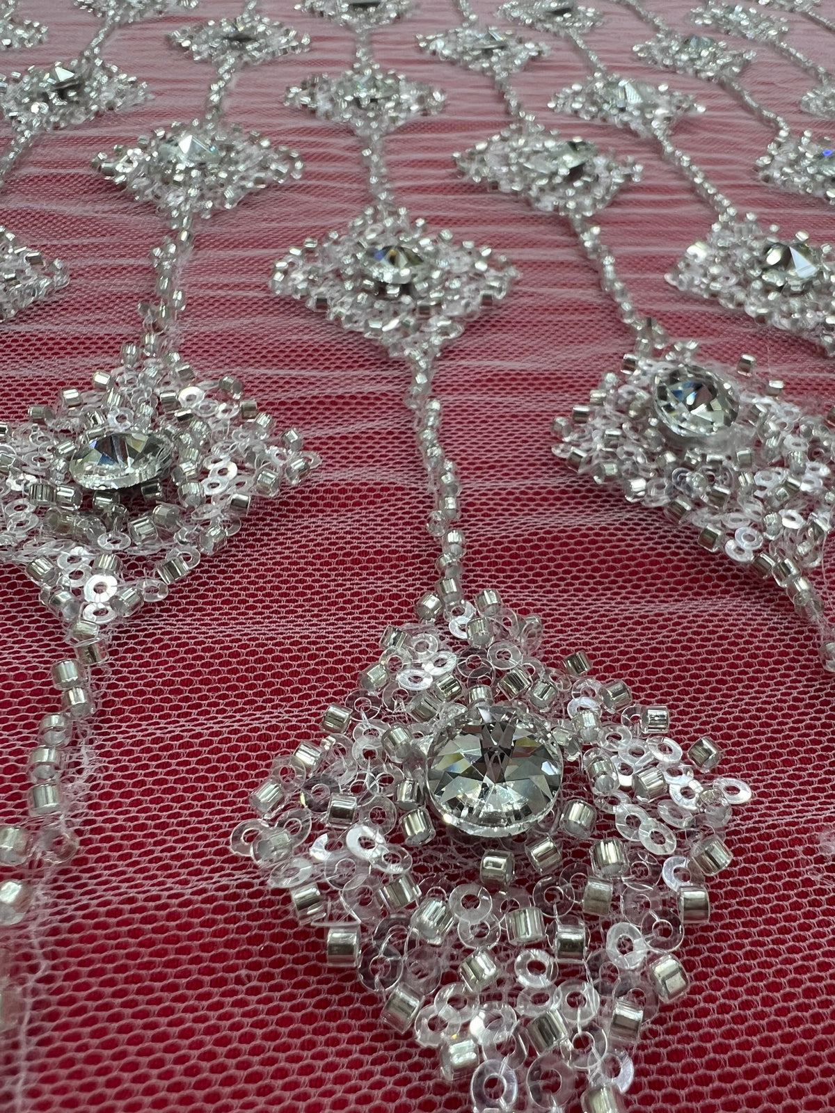 Embroidered lace with shimmering stones in a graduated geometric design