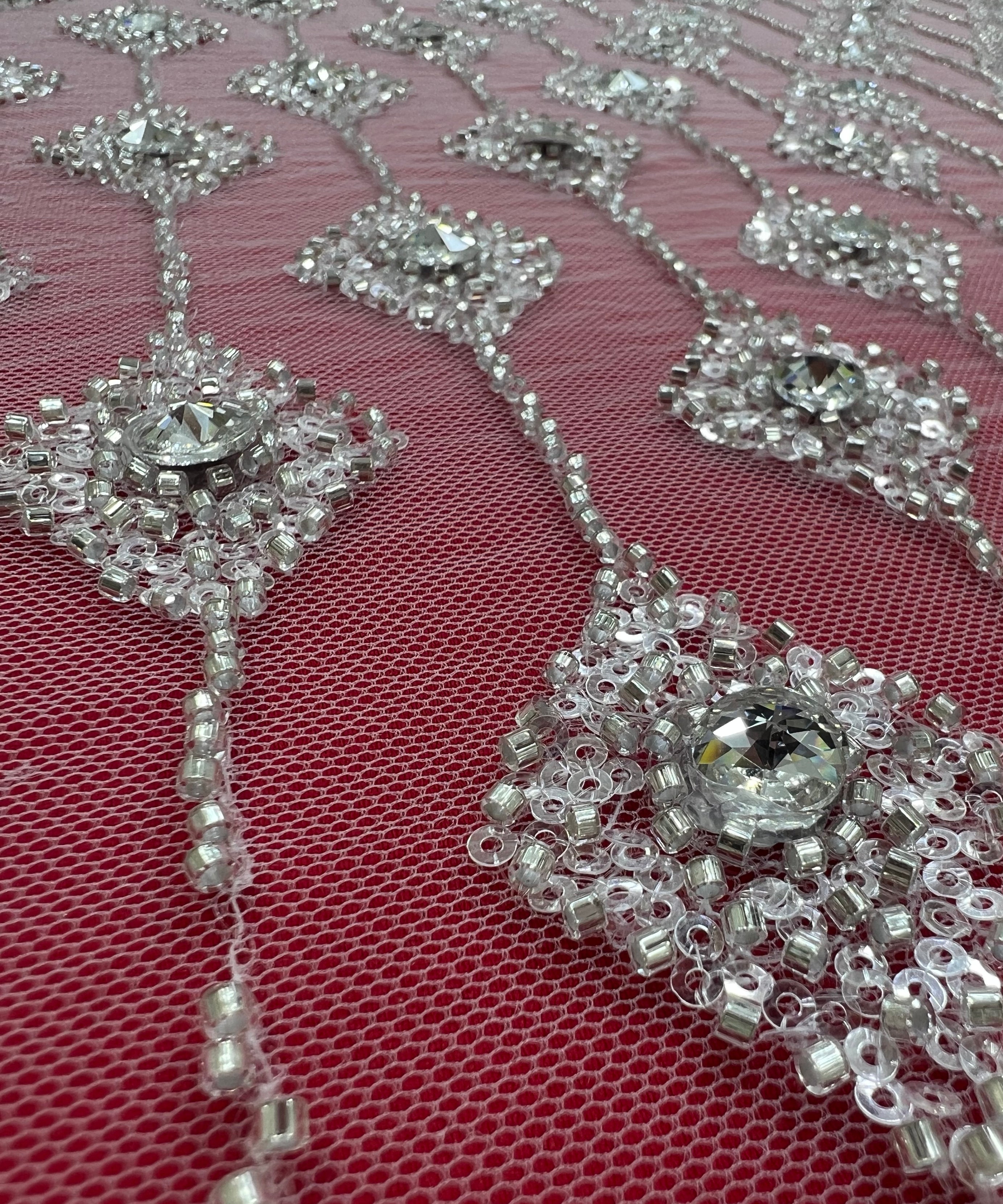 Embroidered lace with shimmering stones in a graduated geometric design