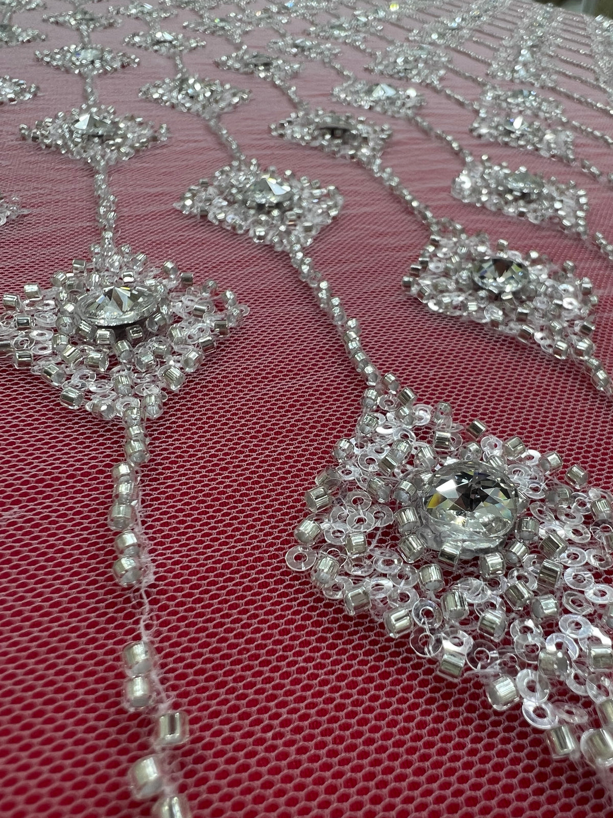 Embroidered lace with shimmering stones in a graduated geometric design