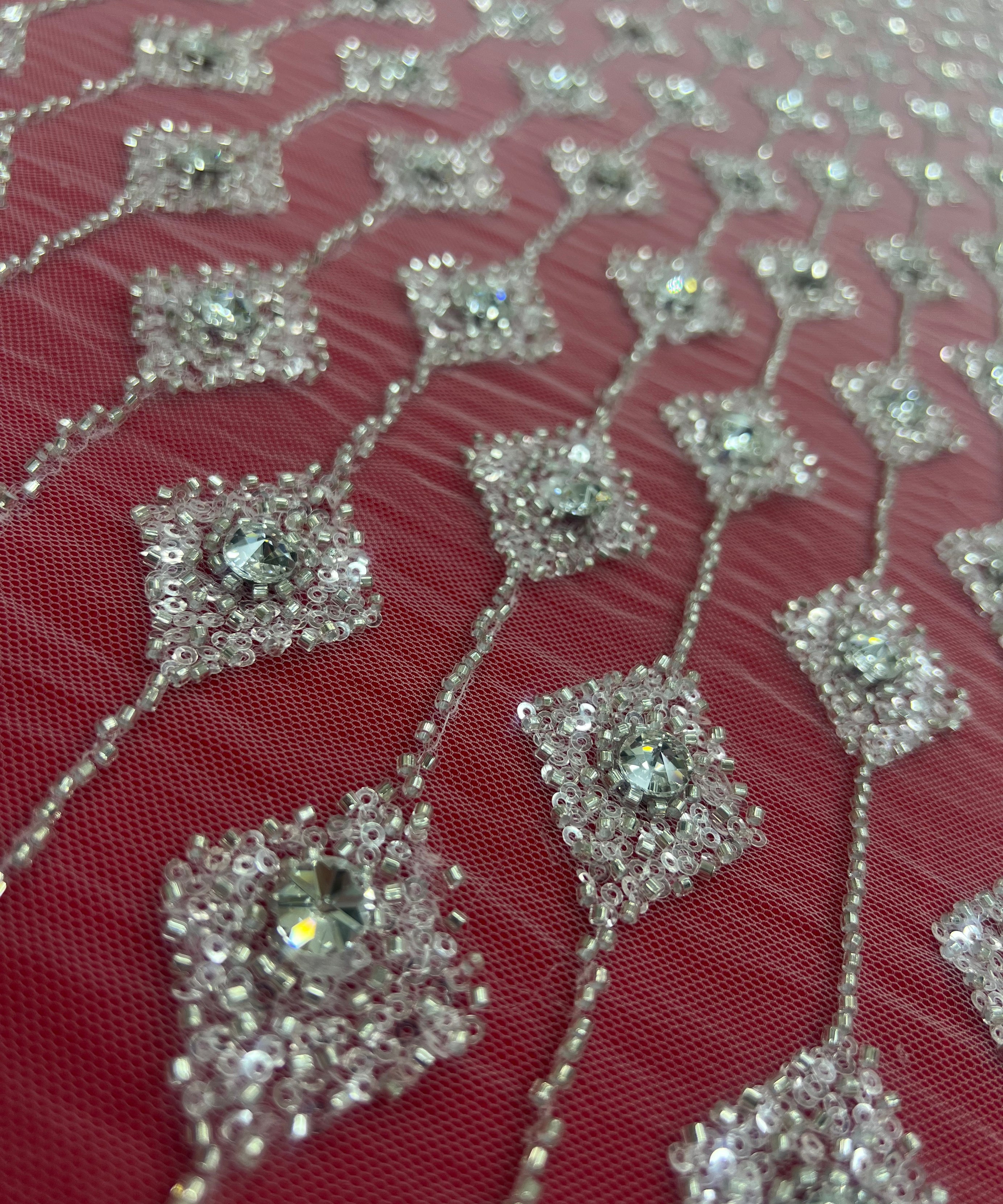 Embroidered lace with shimmering stones in a graduated geometric design