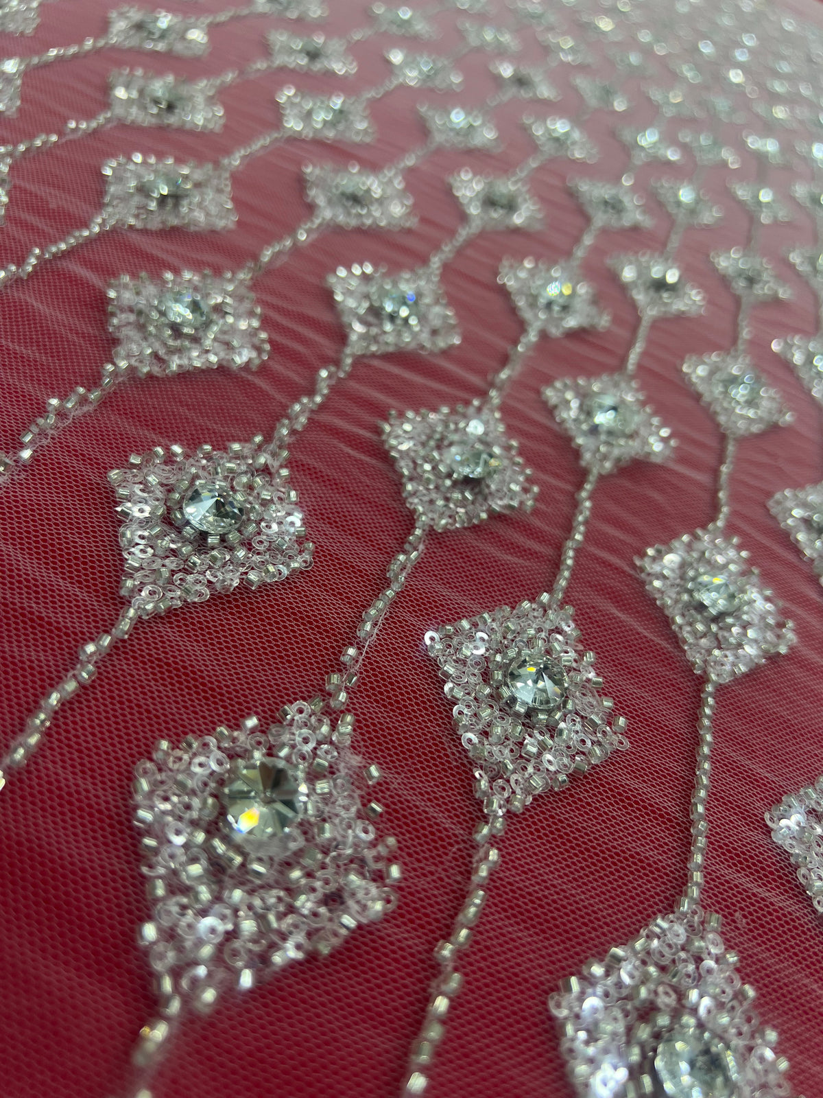 Embroidered lace with shimmering stones in a graduated geometric design